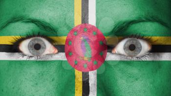 Close up of eyes. Painted face with flag of Dominica