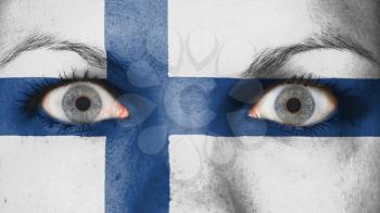 Close up of eyes. Painted face with flag of Finland
