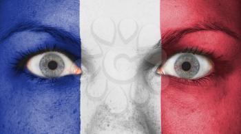 Close up of eyes. Painted face with flag of France
