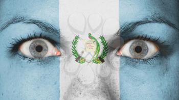 Close up of eyes. Painted face with flag of Guatemala