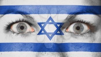 Close up of eyes. Painted face with flag of Israel