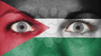 Close up of eyes. Painted face with flag of Jordan