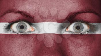 Close up of eyes. Painted face with flag of Latvia