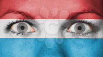 Close up of eyes. Painted face with flag of Luxembourg