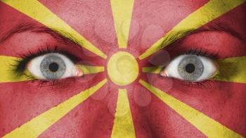 Close up of eyes. Painted face with flag of Macedonie