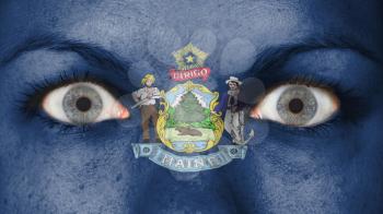Close up of eyes. Painted face with flag of Maine