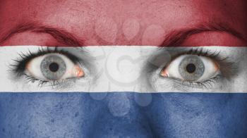 Close up of eyes. Painted face with flag of Netherlands