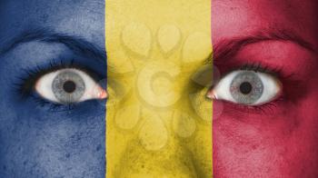 Close up of eyes. Painted face with flag of Romania