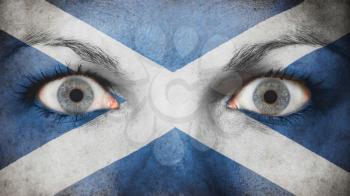 Close up of eyes. Painted face with flag of Scotland