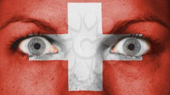 Close up of eyes. Painted face with flag of Switzerland