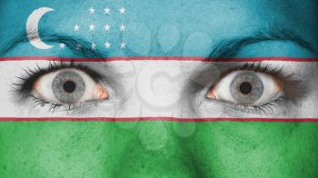 Close up of eyes. Painted face with flag of Uzbekistan