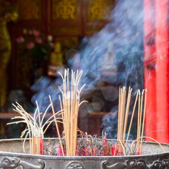 Incense furnace with smoking joss stick, concept of Vietnamese offering ritual
