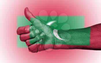 Old woman giving the thumbs up sign, isolated, flag of Maldives