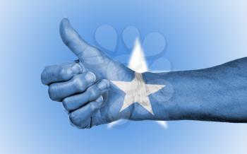 Old woman giving the thumbs up sign, isolated, flag of Somalia