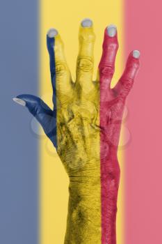 Hand of an old woman wrapped in flag of Chad