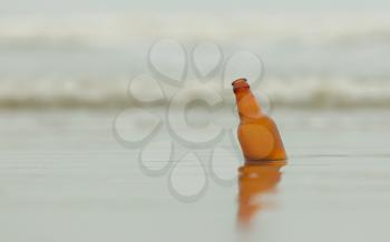 Old bottle of beer on the beach
