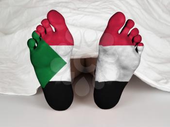 Feet with flag, sleeping or death concept, flag of Sudan