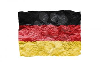 Close up of a curled paper on white background, print of the flag of Germany
