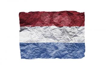 Close up of a curled paper on white background, print of the flag of Holland