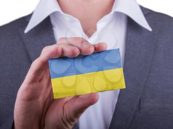 Businessman showing card, matte paper effect, Ukraine