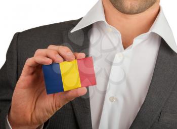 Businessman is holding a business card, flag of Romania