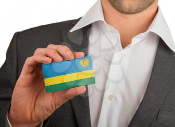 Businessman is holding a business card, flag of Rwanda