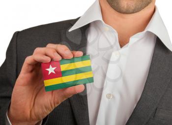 Businessman is holding a business card, flag of Togo