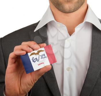 Businessman is holding a business card, flag of Iowa