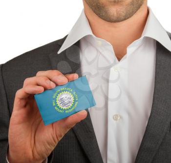 Businessman is holding a business card, flag of South Dakota