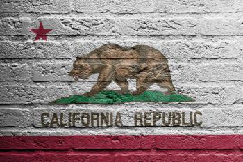 Brick wall with a painting of a flag isolated, California