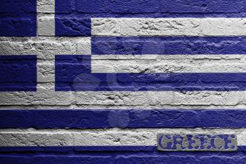 Brick wall with a painting of a flag isolated, Greece