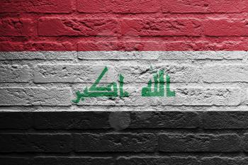 Brick wall with a painting of a flag isolated, Iraq