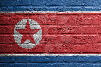 Brick wall with a painting of a flag isolated, North Korea