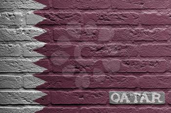 Brick wall with a painting of a flag isolated, Qatar