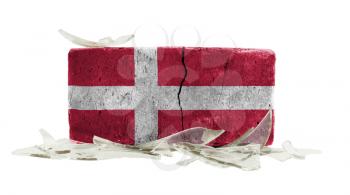 Brick with broken glass, violence concept, flag of Denmark