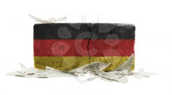 Brick with broken glass, violence concept, flag of Germany