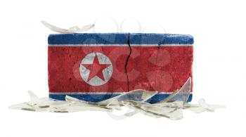 Brick with broken glass, violence concept, flag of North Korea