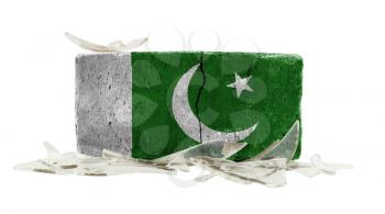 Brick with broken glass, violence concept, flag of Pakistan