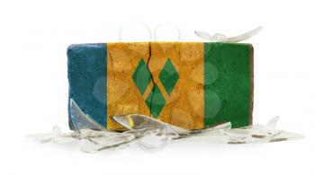 Brick with broken glass, violence concept, flag of Saint Vincent and the Grenadines