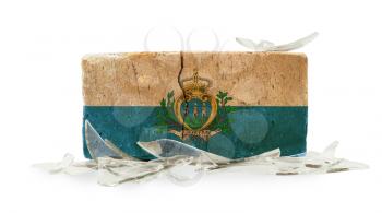 Brick with broken glass, violence concept, flag of San Marino