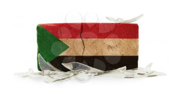 Brick with broken glass, violence concept, flag of Sudan