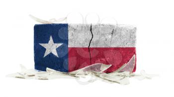 Brick with broken glass, violence concept, flag of Texas
