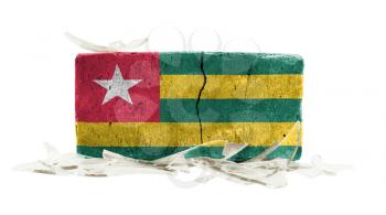 Brick with broken glass, violence concept, flag of Togo
