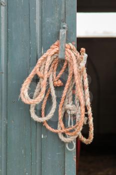 Old rope hanging at a door on a dutch farm