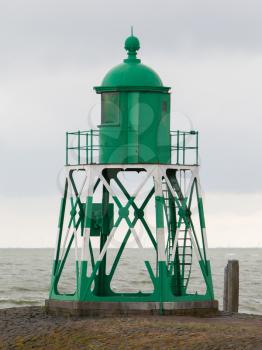 Green light beacon in a dutch harbor