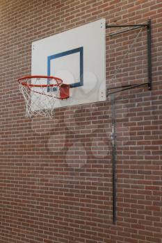 Basketball hoop on an oldbrick wall, gym