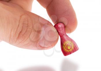 Wooden pawn with a painting of a flag, Kyrgyzstan