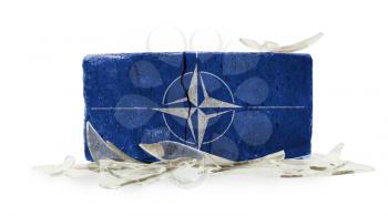 Brick with broken glass, violence concept, NATO