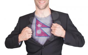 Businessman opening suit to reveal shirt with flag, Nepal