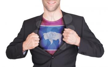 Businessman opening suit to reveal shirt with state flag (USA), Wyoming